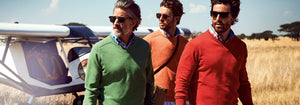 Three mens wearing colored jumpers
