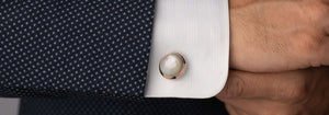 Man wearing round pearl shirt studs