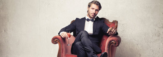 Man in a chair wearing a evening suit